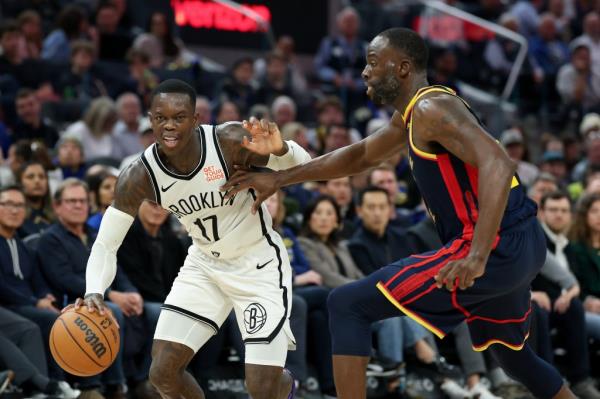 Dennis Schroder #17 of the Brooklyn Nets is guarded by Draymond Green #23 of the Golden State Warriors in the first half at Chase Center on November 25, 2024 in San Francisco, California.