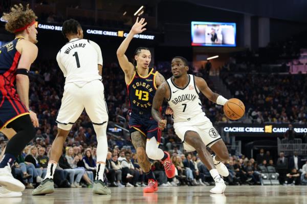 Shake Milton #7 of the Brooklyn Nets shoots over Lindy Waters III #43 of the Golden State Warriors in the first half at Chase Center on November 25, 2024 in San Francisco, California.