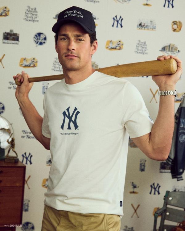 A man holding a NYON x Yankees ba<em></em>seball bat