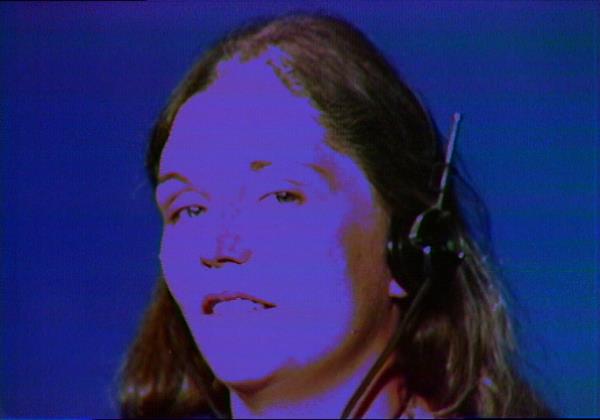 A woman wearing a headset in a 1974 color video titled Boomerang by Richard Serra and Nancy Holt