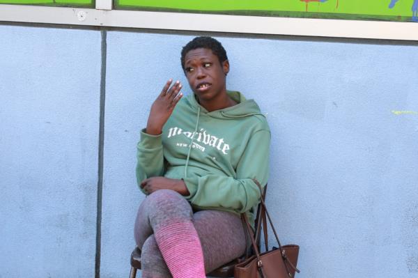 Female perp in green sweater