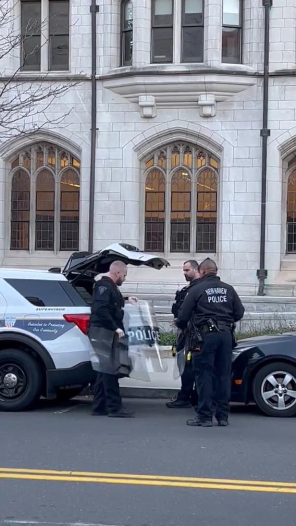 New Haven police are getting riot gear out of their vehicles, and entrances to the plaza are blocked by Yale police cars.