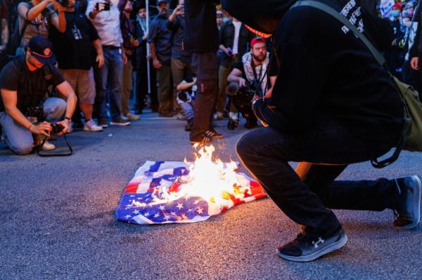 Anti-Israel protesters burning an American flag in the Chicago.