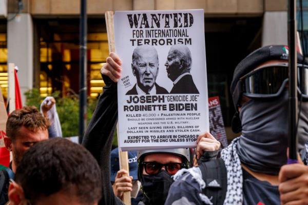 A sign held at the protest accusing President Biden of 