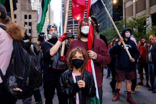 Protesters carrying Palestinian flags near the Israeli consulate.