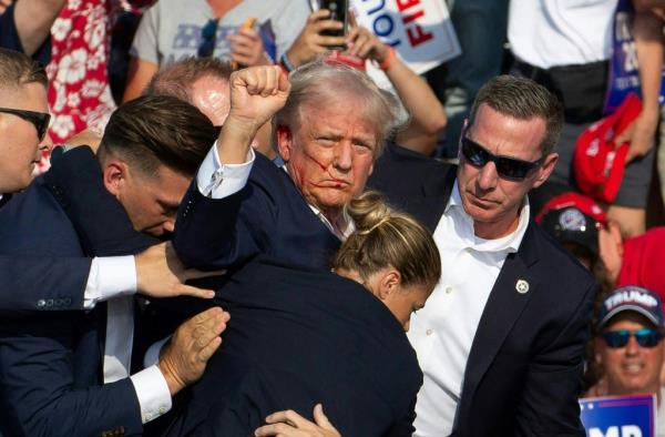 Republican Presidential candidate Do<em></em>nald Trump is seen with blood on his face surrounded by secret service agents as he is taken off the stage at a campaign event at Butler Farm Show Inc., in Butler, Pennsylvania, on July 13, 2024.