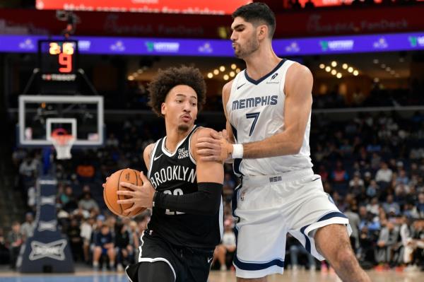 Nets forward Jalen Wilson (22) handles the ball against Memphis Grizzlies forward Santi Aldama (7) in the second half of an NBA basketball game Wednesday, Oct. 30, 2024, in Memphis, Tenn.