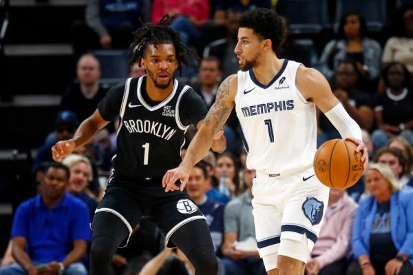 Memphis Grizzlies guard Scotty Pippen Jr. (1) dribbles as Brooklyn Nets forward Ziaire Williams (1) defends during the first half at FedExForum.