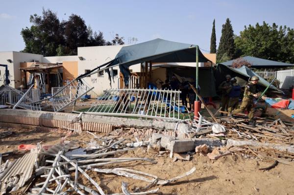 Israeli soldiers stand in a damaged school in Kibbutz Beeri near the Gaza Strip border following a Palestinian militant attack on October 7.