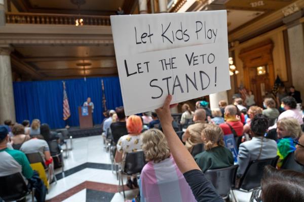 People listen to speakers during a rally protesting lawmakers gathering to override Gov. Eric Holcomb's veto of HB1941, Tuesday, May 24, 2022 at the Indiana Statehouse in Indianapolis, Ind.