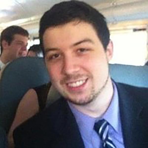 Andrew Croghan, Chief Operating Officer of Alameda Research, smiling in a suit