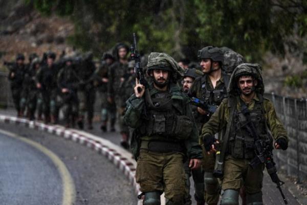 TOPSHOT - Israeli army soldiers patrol an undisclosed area in northern Israel bordering Lebanon on October 15, 2023, amid the o<em></em>ngoing battles between Israel and the Palestinian Islamist group Hamas. Lebanon's Hezbollah and Israel exchanged deadly border fire on October 15, with the Iran-backed group claiming respo<em></em>nsibility for strikes that Israel said killed a civilian, further raising cross-border tensions during Israel's war with Gaza-ba<em></em>sed militants. (Photo by Aris MESSINIS / AFP) (Photo by ARIS MESSINIS/AFP via Getty Images) *BESTPIX*