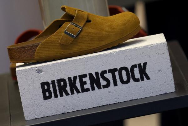 Birkenstock shoe displayed on a white block in a store window in London, Britain.