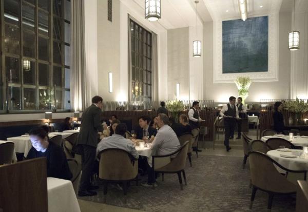 A group of people dining at the NYC staple restaurant, Eleven Madison Park.