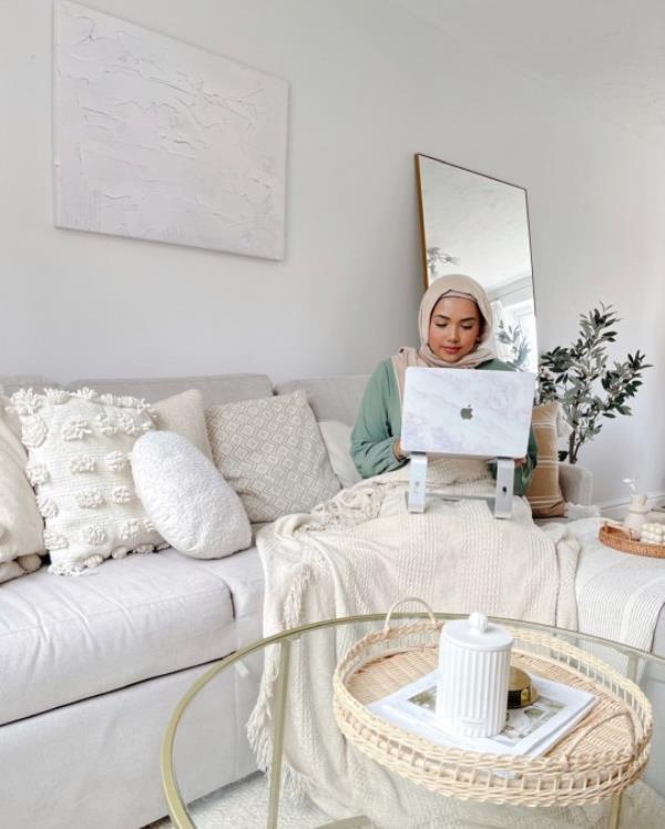 Aziza sitting in her living room. 