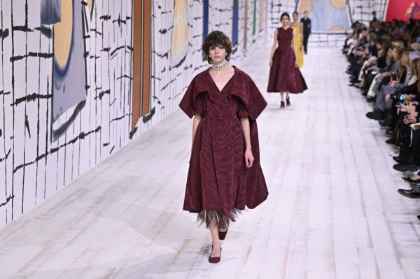 Maroon dress with feather underskirt peeking out at bottom