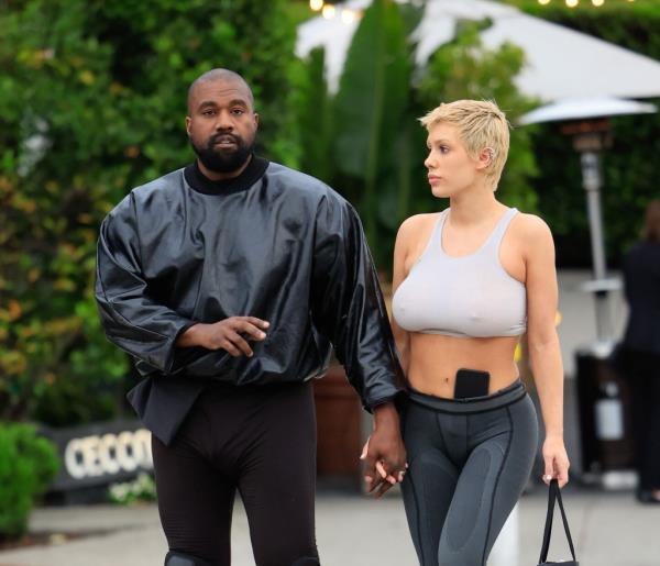 Kanye holding hands with Bianca Censori. 