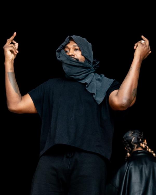 Kanye with his arms up. 