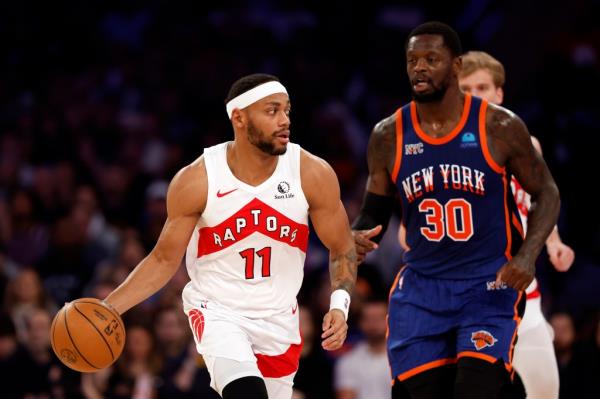 Bruce Brown #11 of the Toro<em></em>nto Raptors dribbles as Julius Randle #30 of the New York Knicks defends during the second half at Madison Square Garden on January 20, 2024 in New York City.