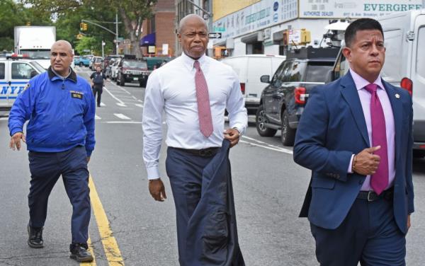 Mayor Eric Adams walking down the street. 