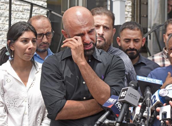 Maim Saeidi, one of Hamod's sons, cries during his dad's funeral. 
