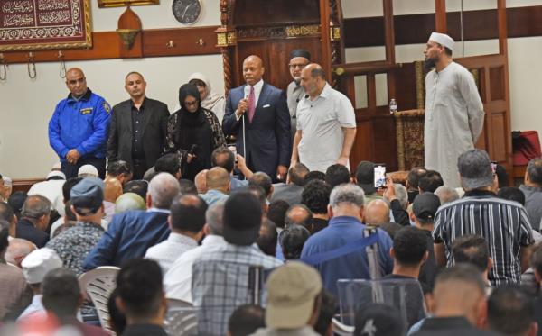 Adams addresses the funeral mourners. 