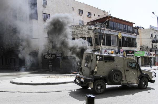 Reinforcements from Israeli military vehicles storm the Jenin refugee camp in the northern West Bank during a military operation in search of Palestinian militants from the Jenin Brigade.