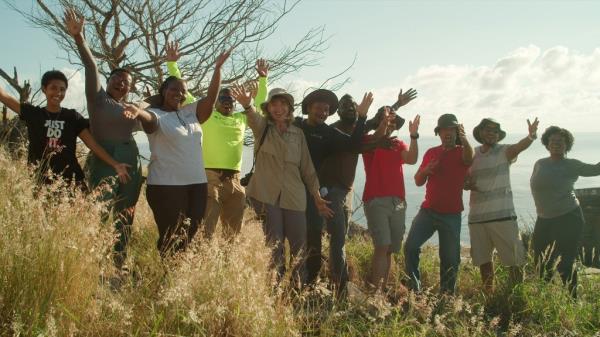 The Redo<em></em>nda wildlife mo<em></em>nitoring team credited for transforming the o<em></em>nce barren island into a tropical refuge, seen waving in a group photo taken on the island.