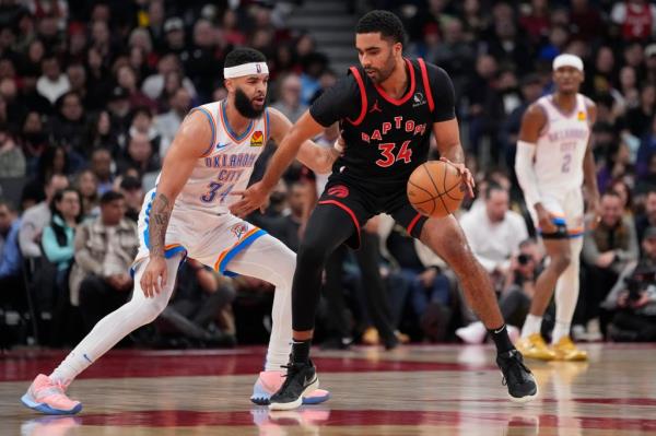 Toro<em></em>nto Raptors forward Jo<em></em>ntay Porter (34) controls the ball against Oklahoma City Thunder forward Kenrich Williams (34) during the first half at Scotiabank Arena. 