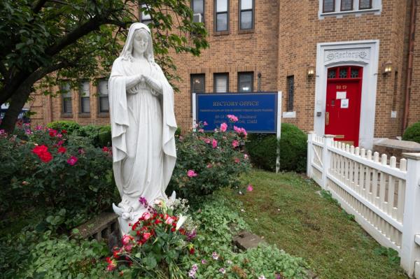The outside of the church and the vandalized statue.