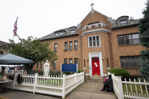 The outside of the church and the vandalized statue