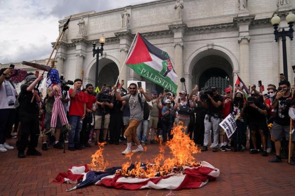 Anti-Israel demo<em></em>nstrators burn a U.S. flag and an effigy depicting Israeli Prime Minister Benjamin Netanyahu, on the day of Netanyahu's address to a joint meeting of Congress, on Capitol Hill in Washington.