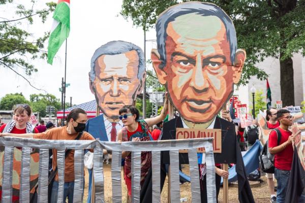 Large posters of Netanyahu and President Biden being carried by demonstrators. 
