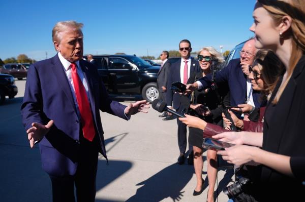 Republican presidential nominee former President Do<em></em>nald Trump speaks with reporters upon arrival at Philadelphia Internatio<em></em>nal Airport, Sunday, Oct. 20, 2024, in Philadelphia.