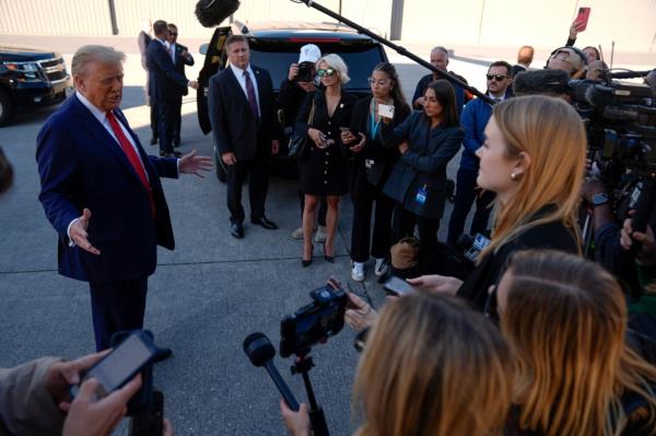 Republican presidential nominee former President Do<em></em>nald Trump talks with reporters as he arrives at Harrisburg Internatio<em></em>nal Airport, Sunday, Oct. 20, 2024, in Harrisburg, Pa.