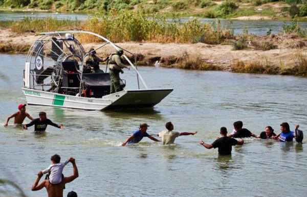 Migrants crossed the Rio Grande river from Mexico into the United States before they were processed and taken into custody by U.S. Customs and Border Protection officers on Sep. 25, 2023 in Eagle Pass, Texas.