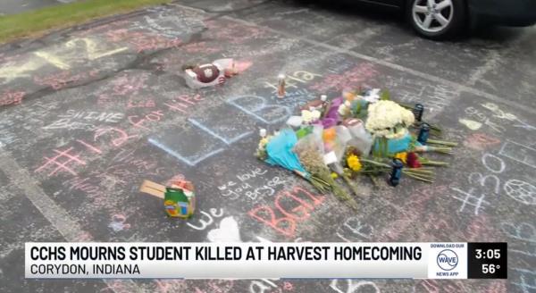 Flowers and messages are left at Gerlach's parking space at Corydon Central High School.