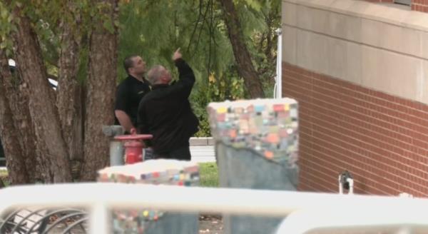Police investigate the scene a day after the shooting in New Albany.