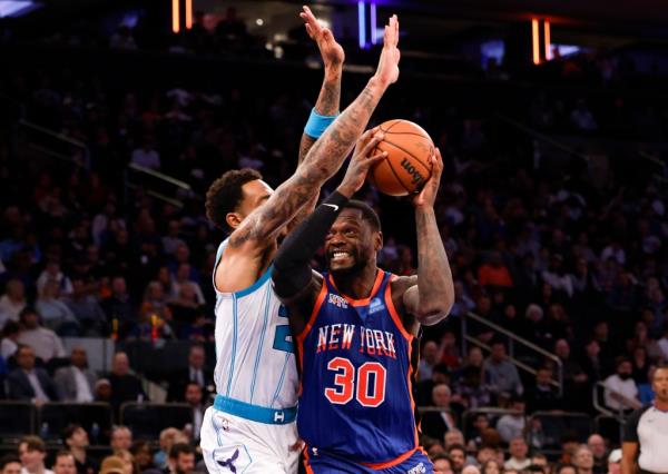 New York Knicks forward Julius Randle goes up for a shot as Charlotte Hornets forward P.J. Washington defends in the second half at Madison Square Garden in New York, Sunday, November 12, 2023.