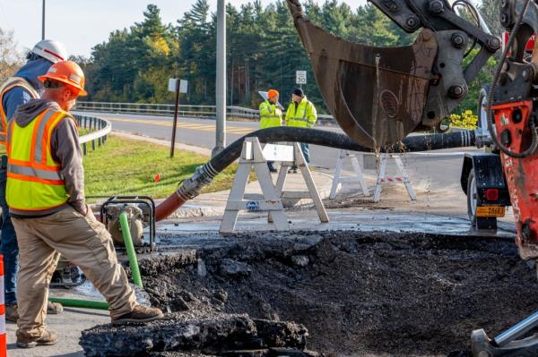 Workers at the scene of a water main rupture in Watertown, New York on October 19, 2023.