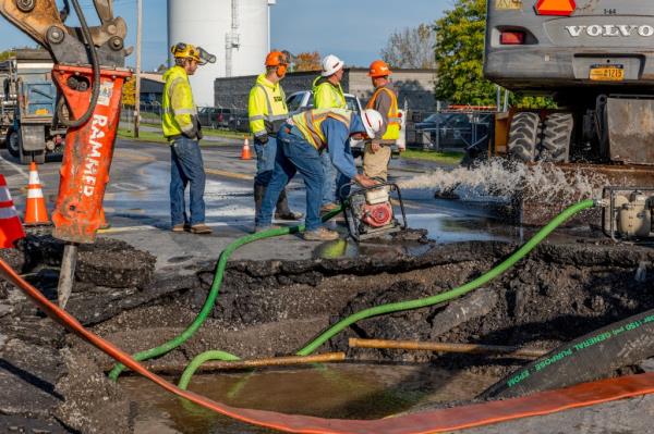 Workers at the scene of a water main rupture in Watertown, New York on October 19, 2023.