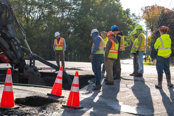 Workers at the scene of a water main rupture in Watertown, New York on October 19, 2023.