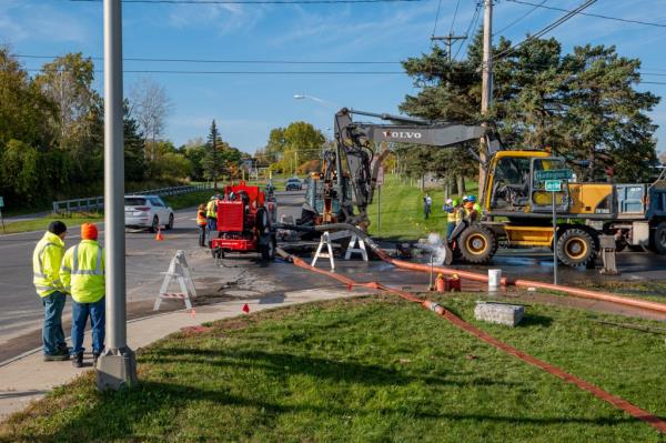 Workers at the scene of a water main rupture in Watertown, New York on October 19, 2023.