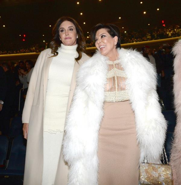 Caitlyn Jenner with Kris Jenner smiling wearing white fur. 