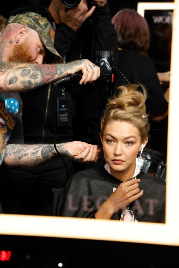 Gigi Hadid getting her hair and makeup done backstage at the 2024 VS Fashion Show