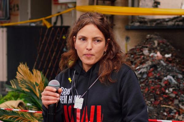Released hostage Amit Soussana, kidnapped on the deadly October 7 attack by Palestinian Islamist group Hamas, talks to the press in front of her destroyed home