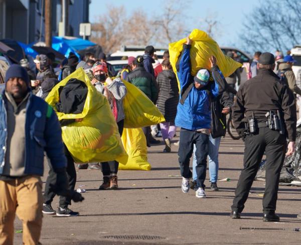 Migrants carry their belo<em></em>ngings in Denver.