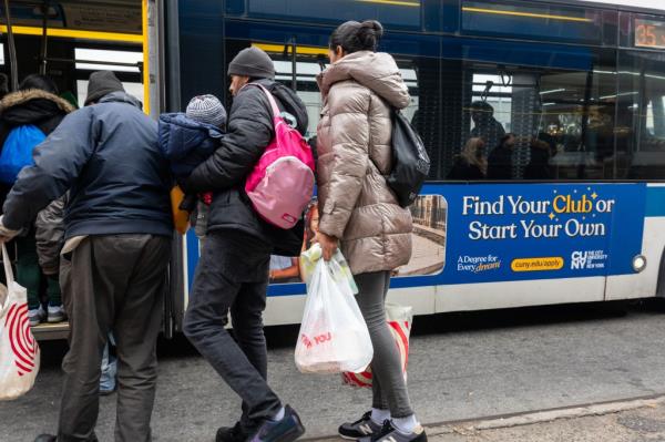 Recently arrived migrants board a bus back to their temporary tent shelters at Floyd Bennett Field in Brooklyn.