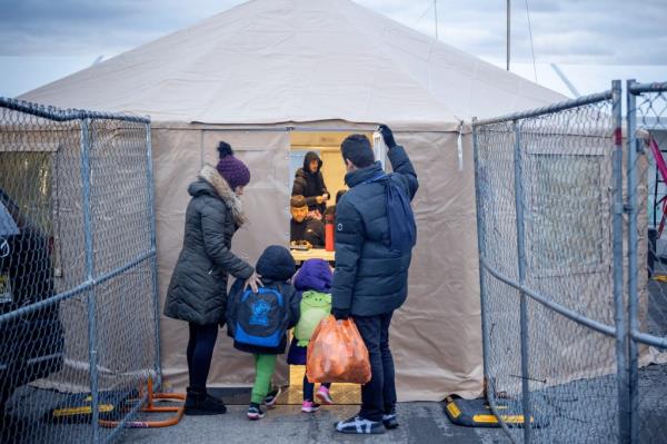 A migrant family arrives at Floyd Bennett Field