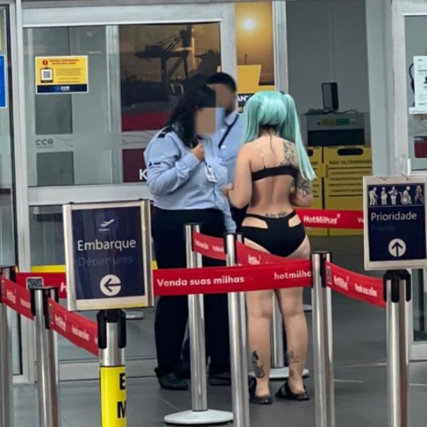 Story from Jam Press (Cosplay Flight Ban) Pictured: Kine-Chan at the airport. 'I was banned from boarding my flight and told to go home and change clothes' A woman claims to have been banned from boarding a flight after dressing in cosplay at the airport. Kine-Chan, a 21-year-old model, influencer and o<em></em>nlyFans co<em></em>ntent creator, appeared at Navegantes Airport in Brazil, dressed in ?Rebecca's Cosplay?. Wearing o<em></em>nly a black bikini, turquoise wig and black sandals, she claims she was told she wasn?t dressed appropriately and was banned from boarding the flight. Sharing the alleged incident on Instagram (@kinechan2.0) with her 612,000 followers, Kine-Chan wrote: ?Xuxus, a very annoying situation happened this weekend!? ?I tried to board at Navegantes airport dressed as Rebecca's Cosplay for an event. ?I already knew that I could be late, so I was dressed so as not to waste time and could go straight to my room. ?But I was told to go home and change clothes because the one I was wearing was not ?appropriate?. ?I explained that I was going to an event. ?Anyway Rebecca barred lol.? Dressed as the fictio<em></em>nal character Rebecca from the anime series Cyberpink: Edgerunners, Kine-Chan do<em></em>nned the skimpy outfit before being allegedly stopped by airport security and barred from co<em></em>ntinuing to her flight. Fans have rushed to comment on her antics, many thinking she has gone too far. ?Kine i love you but for the love of God... you could have put on an easy pull-up outfit, like a falling dress or even a button-down blouse,? commented Jazz. [sic] Bruno added: ?THEY WERE RIGHT, YOU COULD HAVE PUT THAT CLOTHES ON THERE, THEY WERE SURE, NOT GOING TO LET YOU BOARD.? [sic] Page wrote: ?AMG, it didn?t hurt to wear a dressing gown on top.? [sic] ?Man I work shows and my schedule in between shows is pretty short... I'm going with my costume and ON TOP I'll put a robe or an overalls! Here's the tip for you,? said Leticia. [sic] Jam Pres